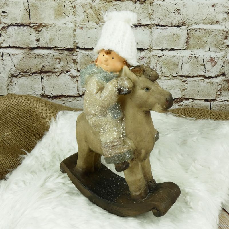 Zimní figurka- holčička na houpacím koni, 23 cm