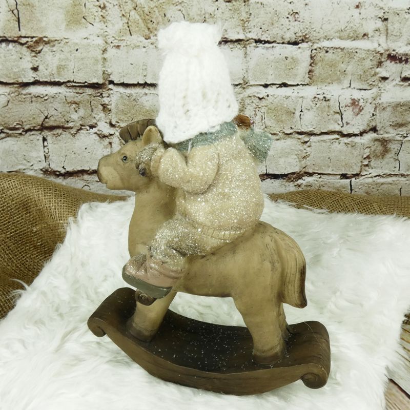 Zimní figurka- holčička na houpacím koni, 23 cm
